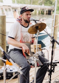 a man playing an accordion on a dock