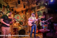 a group of people playing music in a bar